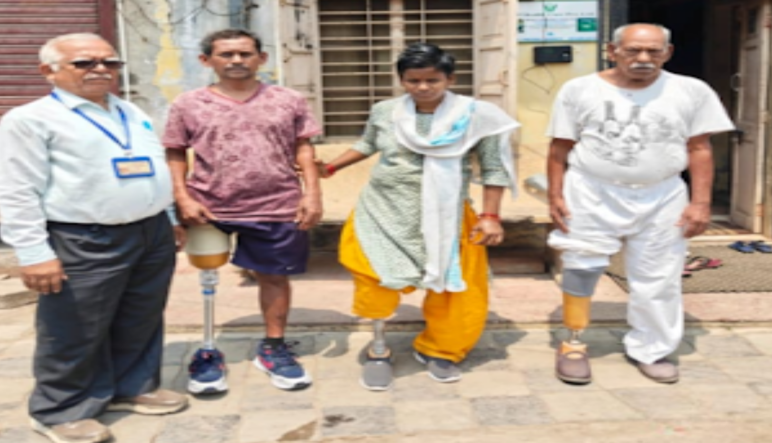 Rajesh Krishna Chaudhary with prosthetic leg standing with Seva Yagna team